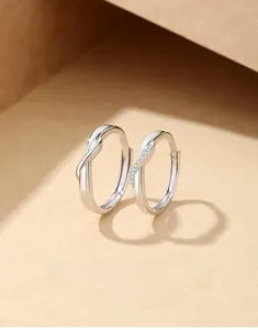 Close-up of S925 sterling silver couple rings with twisted design and cubic zirconia