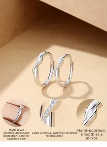 Close-up of S925 sterling silver couple rings featuring knot design and zircon inlay