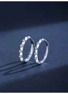 Macro view of S925 sterling silver couple rings with wavy texture and zircon inlays
