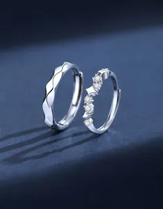 Detail of S925 sterling silver couple rings showing wave texture and zircon star setting