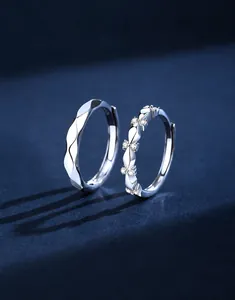 Macro detail of S925 sterling silver couple rings showing inner stamps and pave zircon stones