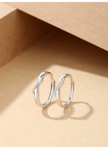Close-up of S925 sterling silver couple rings with Mobius design and fine diamond inlay