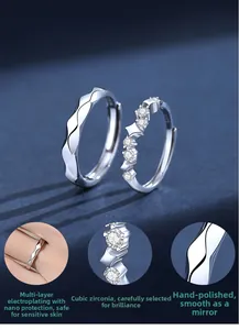 Detailed macro view of S925 sterling silver couple rings with cubic zirconia inlay and engraving
