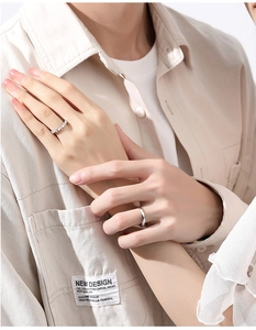 Detail of S925 sterling silver couple rings showing wave texture and pave setting stones