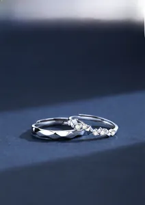 Detailed view of S925 silver couple rings featuring pavé zircons and geometric facets