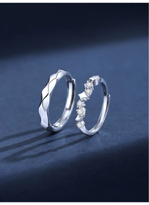 Macro detail of S925 sterling silver hoop earrings with irregular wave design and cubic zirconia
