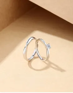 Detailed shot of silver couple rings with heart zirconia and twisted rope pattern