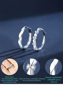 Detail of S925 sterling silver couple rings with cubic zirconia and polished ripple finish