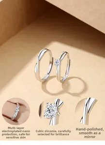 Detail of S925 sterling silver couple rings with heart-cut cubic zirconia and polished finish