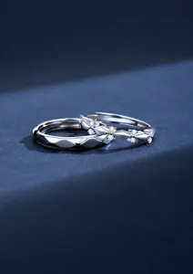 Macro detail of S925 silver couple rings with geometric facets and shimmering zircons