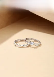 Close-up of S925 sterling silver couple rings with heart-shaped zircon and hallmark