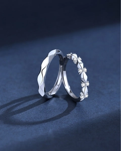 Macro shot of S925 sterling silver couple rings with wavy lines and diamond accents