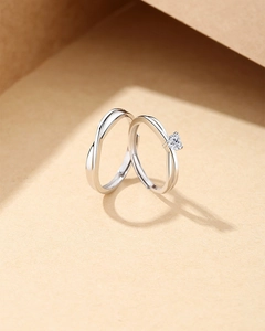 Macro shot of S925 sterling silver couple rings with heart-shaped stone and Mobius twist