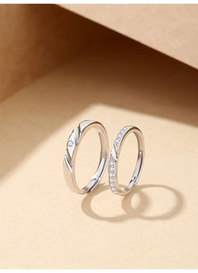 Macro detail of S925 silver Mobius rings featuring elegant diamond settings and polished finish