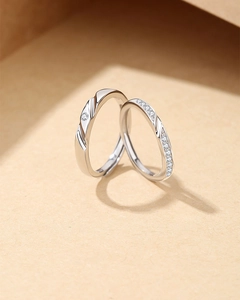 Macro detail of S925 silver Mobius rings with sparkling pavé diamonds on textured surface
