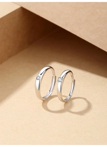 Macro view of couple's S925 silver rings with polished finish and S925 engraving detail