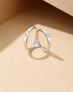 Close-up of S925 sterling silver couple rings with sparkling stones and S925 hallmark