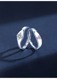 Detail of minimalist S925 silver couple rings with square and heart gemstone inlays