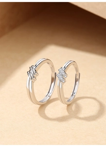 Macro shot of S925 sterling silver knot rings with zircon inlay and interior hallmark