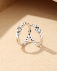 Close-up of S925 sterling silver couple rings with knot design and micro-inlaid zircon