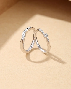 Macro shot of S925 sterling silver Mobius rings casting a heart-shaped shadow