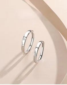 Macro shot of S925 silver couple rings featuring intricate leaf engravings and zircon stones