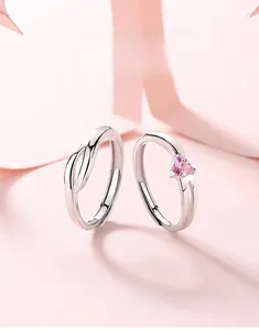 Detailed macro of S925 silver couple rings set with pink heart-shaped crystal stone