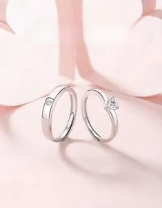 Close-up of 925 silver adjustable couple rings with heart-shaped and round diamonds