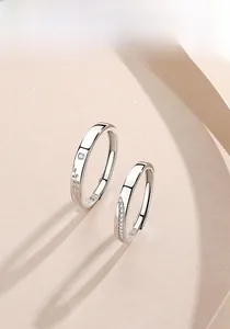 Close-up of S925 sterling silver couple rings with leaf texture and pavé zircon stones