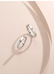 Close-up of S925 sterling silver couple rings with micro-set diamonds and leaf texture