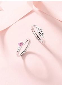 Detailed macro view of S925 sterling silver stamp on romantic couple heart rings