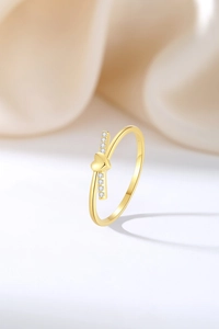 Macro shot of gold S925 sterling silver heart ring with sparkling zircon stones