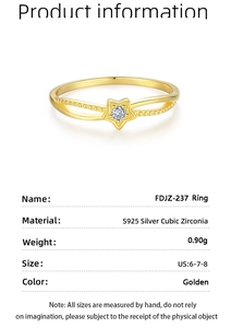 Detail showing S925 sterling silver stamp and cubic zirconia star on golden ring band