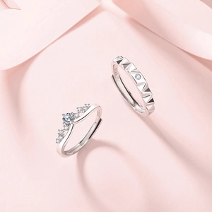 S925 sterling silver crown couple rings with adjustable opening on pink silk fabric