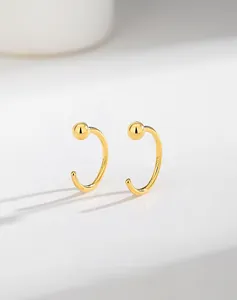 Macro view showing the S925 hallmark on minimalist gold-plated silver C-shaped stud earrings