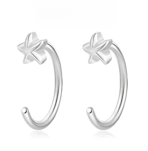 Macro shot of S925 sterling silver C-shaped earrings with delicate star design details