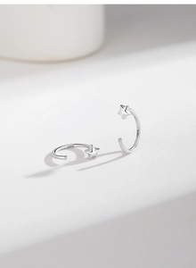 Macro shot of S925 sterling silver C-shaped star earrings with a polished finish