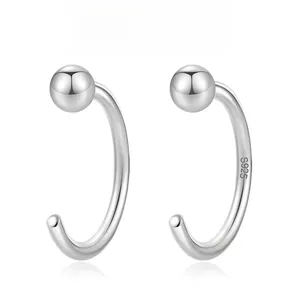 Detail view of S925 sterling silver C-shaped ear studs with smooth metallic finish