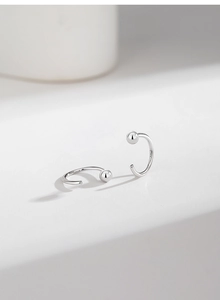 Detailed view of S925 sterling silver C-shaped stud earrings with a high-polished finish