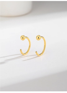 Detailed view of gold plated S925 sterling silver C-shaped stud earrings with polished beads