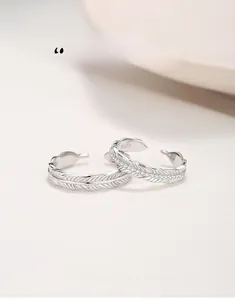 Macro shot of S925 sterling silver feather couple rings with micro-set zircons