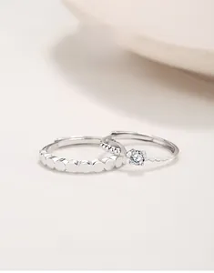 Macro detail of S925 sterling silver couple rings showing single diamond and hallmark
