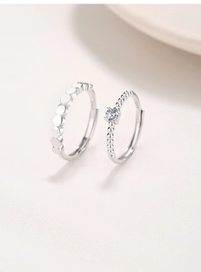 Macro detail of S925 sterling silver adjustable rings with geometric discs and sparkling zircon