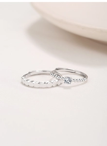 Detail of adjustable S925 sterling silver couple rings with solitaire stone and beaded band