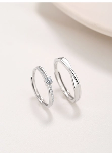 Close-up of S925 sterling silver Mobius couple rings with cubic zirconia inlay