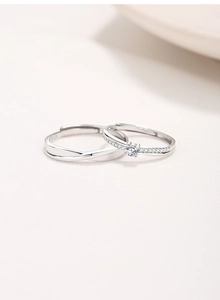 Macro view of S925 sterling silver stamp and sparkling pave diamonds on Möbius rings