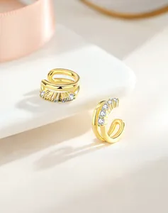 Macro shot of double-layer S925 silver gold-plated ear cuffs with clear cubic zirconia