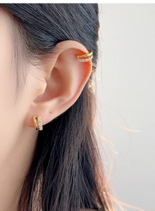 Close-up of double layer gold ear cuff with pavé crystals on a model's ear