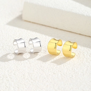 Minimalist irregular concave C-shape ear cuffs in polished gold and silver finishes
