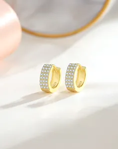 Macro view of S925 silver gold-plated hoop earrings with three rows of micro-pave zircons